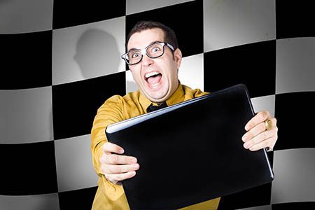 Overexcitable technology sales man selling laptop computers with winning deals. Finish flag background