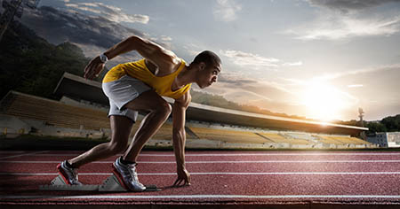 Sport. Sprinter leaving starting blocks on the running track.